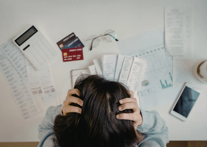 Investor organizing financial reports, market charts, and economic data to filter financial information without feeling overwhelmed